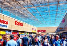 Crowded Costco store with customers and friendly staff.