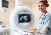 Radiologic technologist preparing imaging equipment in a clinic.