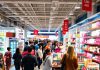 Busy retail store with customers and products on display.