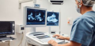 Ultrasound machine in a clinical environment with a technician.