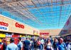 Crowded Costco store with customers and friendly staff.