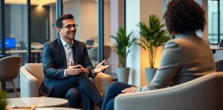 Executive coach engaging with a client in a modern office.