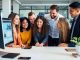 Employers collaborating on job postings in an office setting.