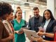 Diverse professionals networking in a modern office setting.