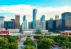 Houston city skyline with people and greenery.