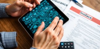 Hands using a tablet with blockchain patterns and insurance documents.